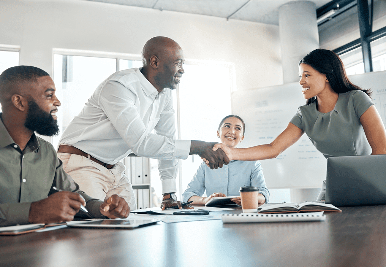 Business people shaking hands in a meeting room.